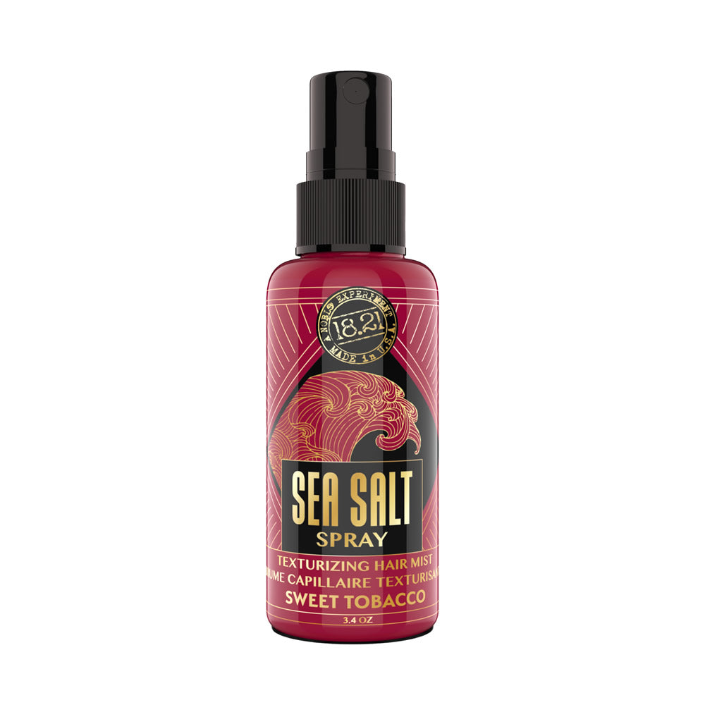 Bottle of 18.21 Manmade sea salt spray with sweet tobacco scent on white background
